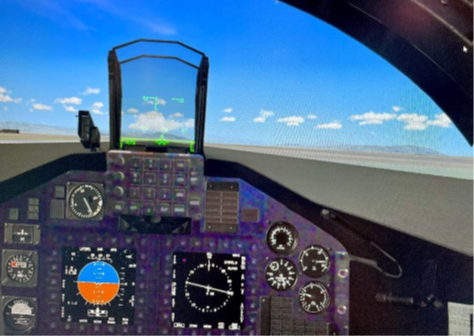 Shown is a T-45C prototype mixed reality cockpit view. Note: Dials, displays, and out-of-the-cockpit view are virtual images while the cockpit panels and buttons are seen in the “real world” via a video pass-through camera.