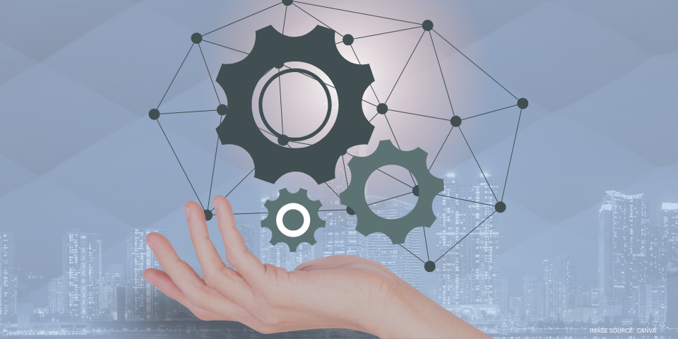a hand holding digital gearwheels with digital network lines