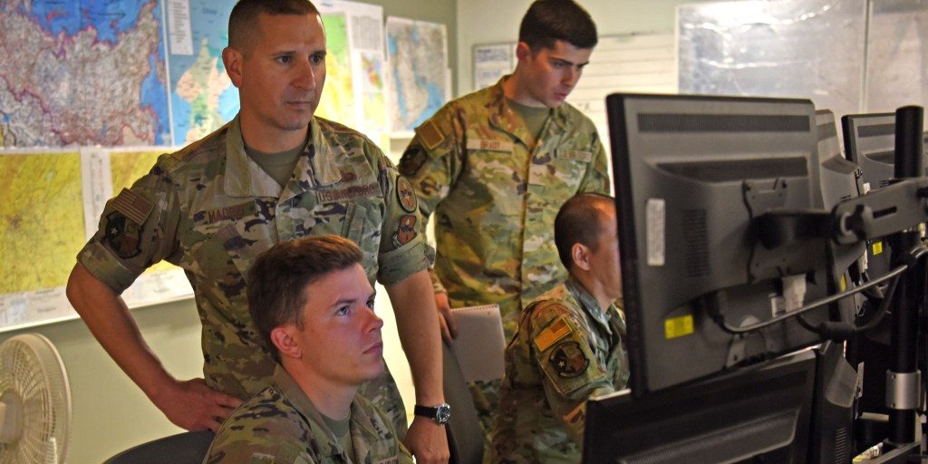 soldiers working at a computer