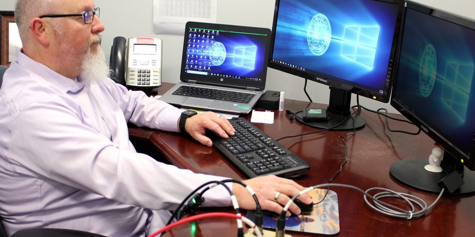 Chris Carr, instrumentation, data and controls engineer at Arnold Air Force Base, demonstrates how the cross-domain solution, or CDS, works. The CDS interface was researched as a solution to allow plant operations systems outside of the plant control room to remain unclassified during classified test programs. As part of an AEDC Innovation Grant project, Carr and several AEDC team members worked together determine whether plant control parameters could be normalized with the addition of a CDS (U.S. Air Force photo by Deidre Moon; this image has been altered by obscuring items for security purposes).